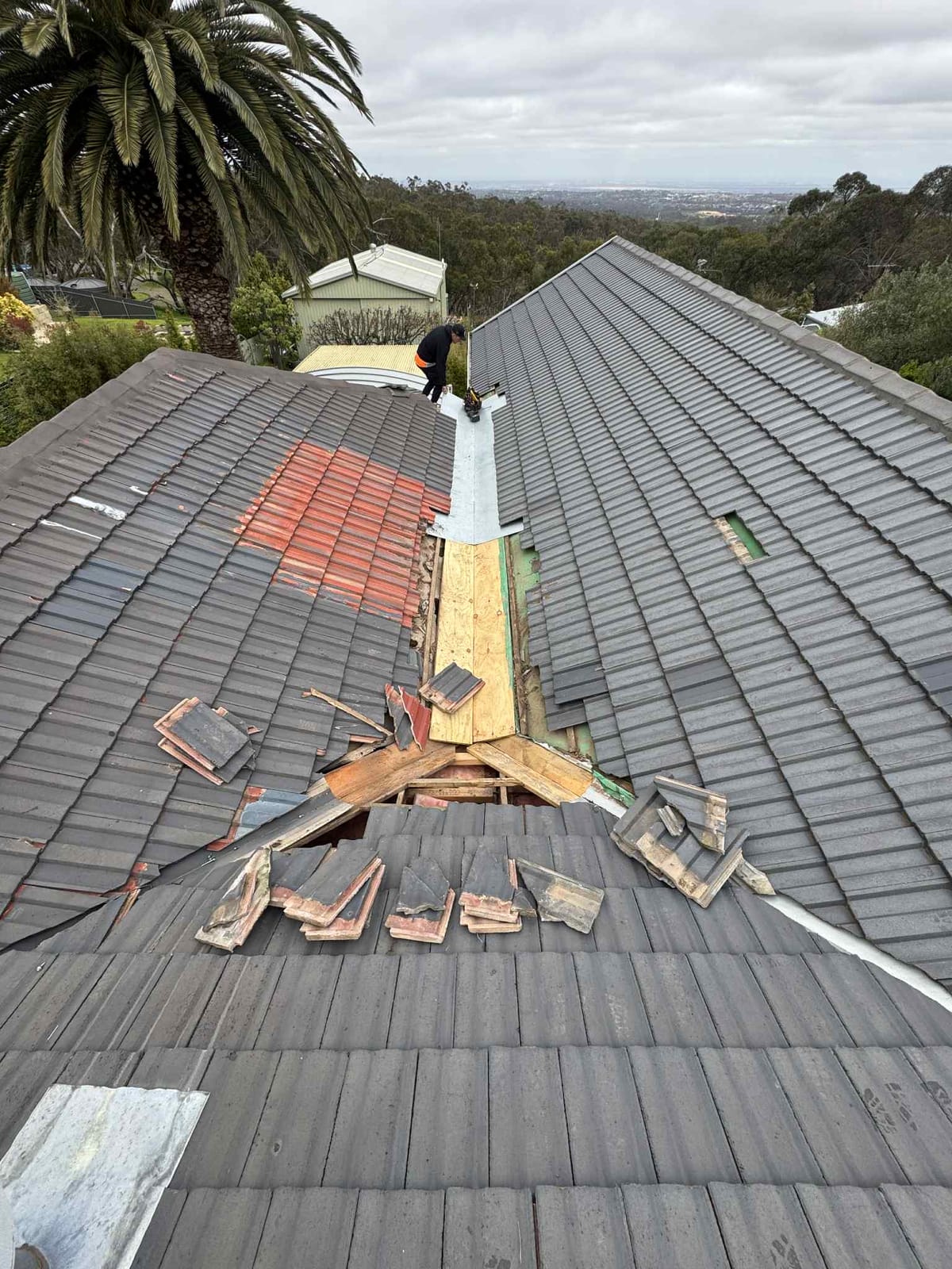 Sam from A1 Roofing carrying out a tile roof repair on an Adelaide home